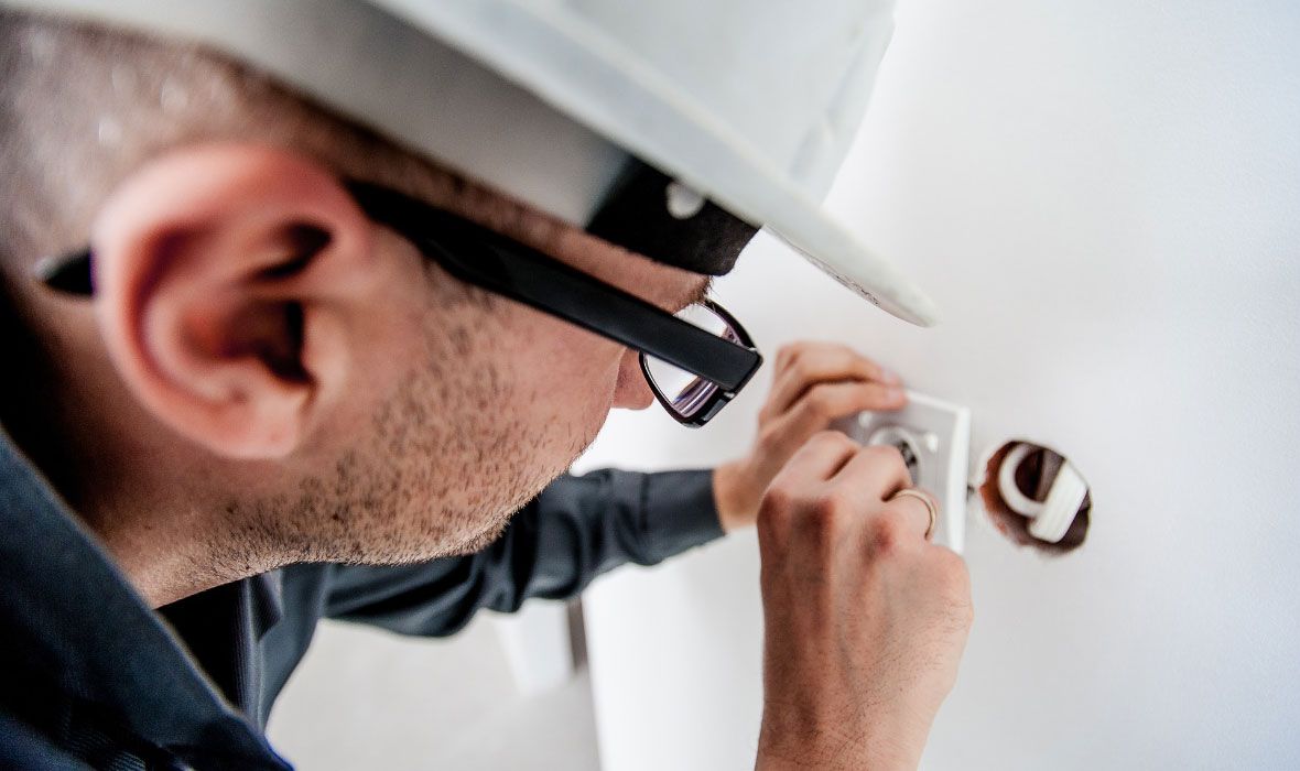 Electrician Repairing Wall Socket